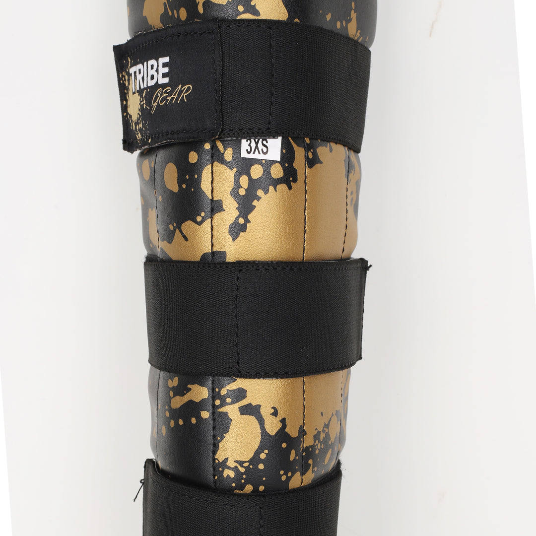 TRIBE GEAR Scheenbeschermers Kids – Gold Splash Edition